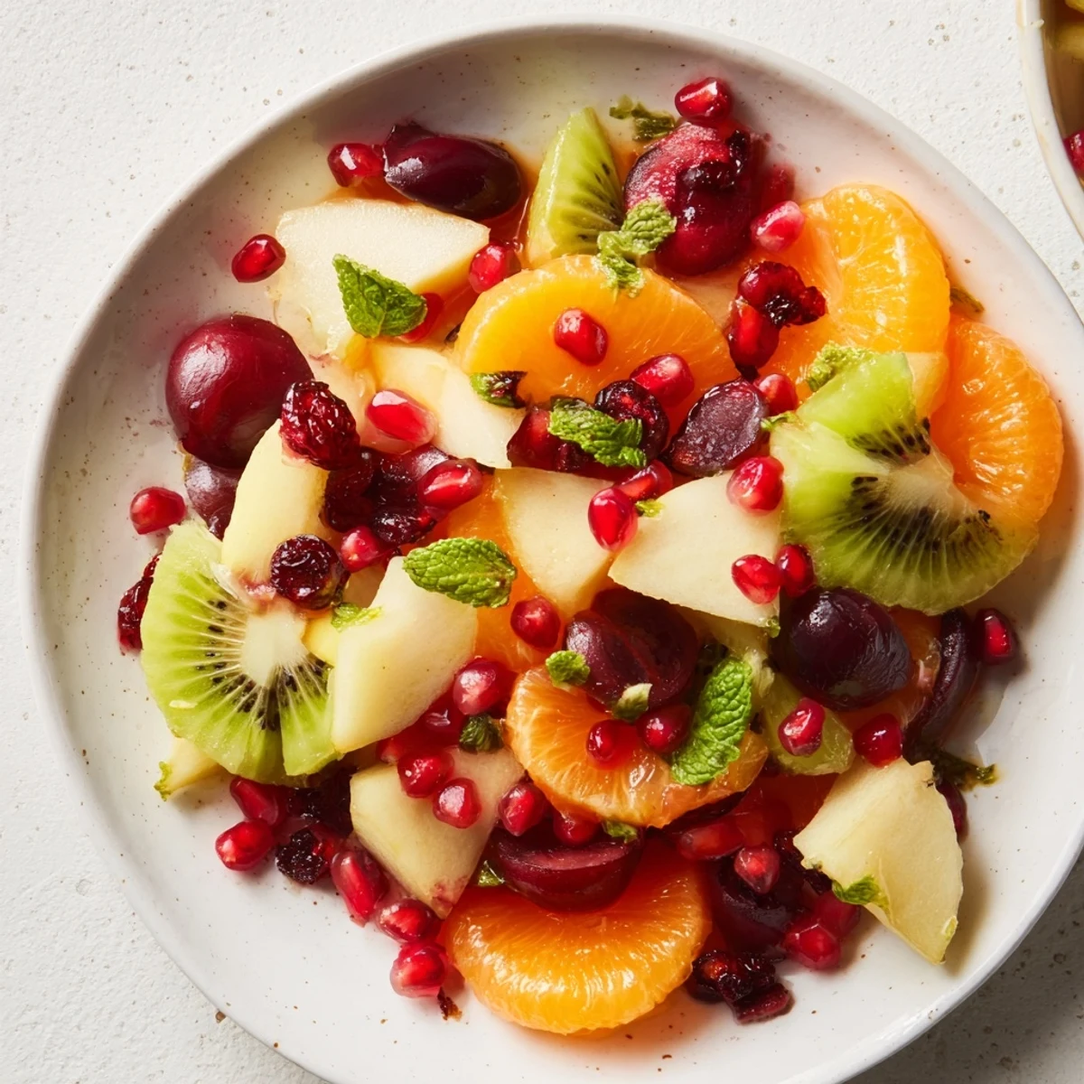 This refreshing Winter Fruit Salad boasts juicy oranges, kiwi, and grapes, coated in a zesty honey lime dressing.