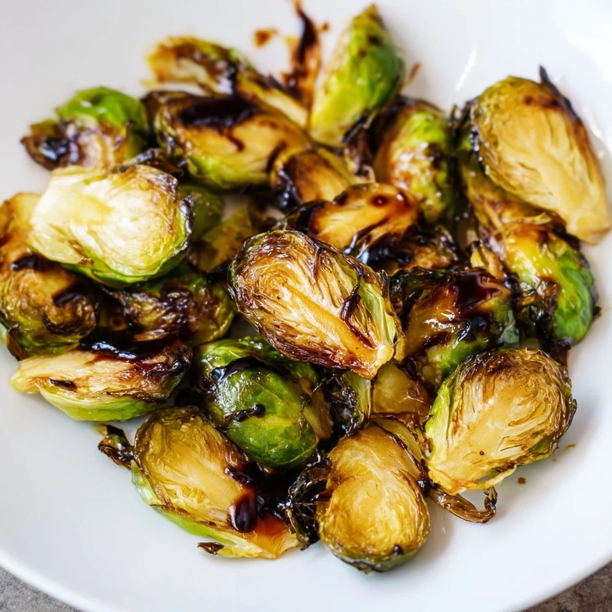 Caramelized Brussels sprouts with balsamic glaze served warm as a delicious vegetarian side dish.