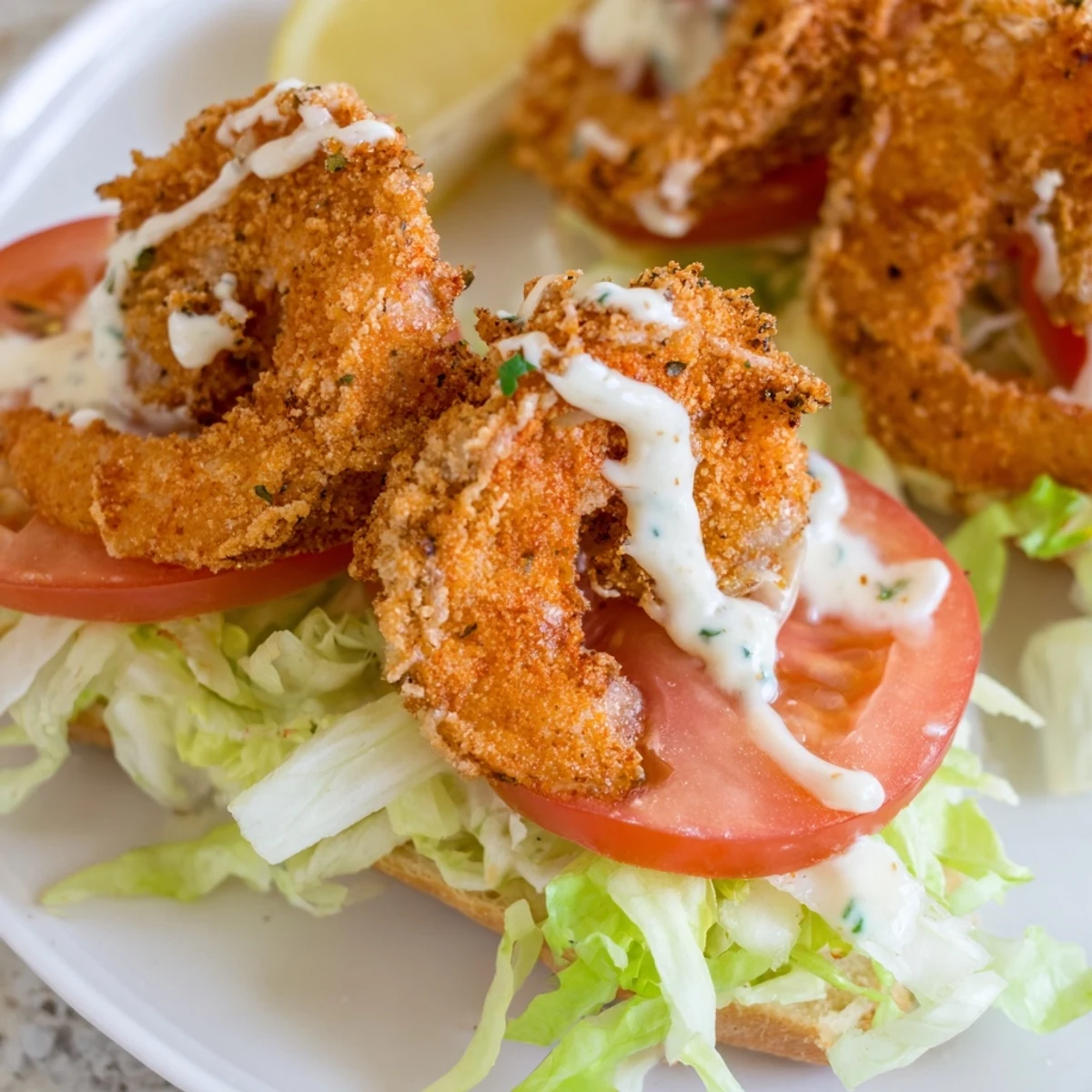 Golden fried shrimp tucked into a soft French roll for a Southern Shrimp Po Boy, served with remoulade, lettuce, and tomato.