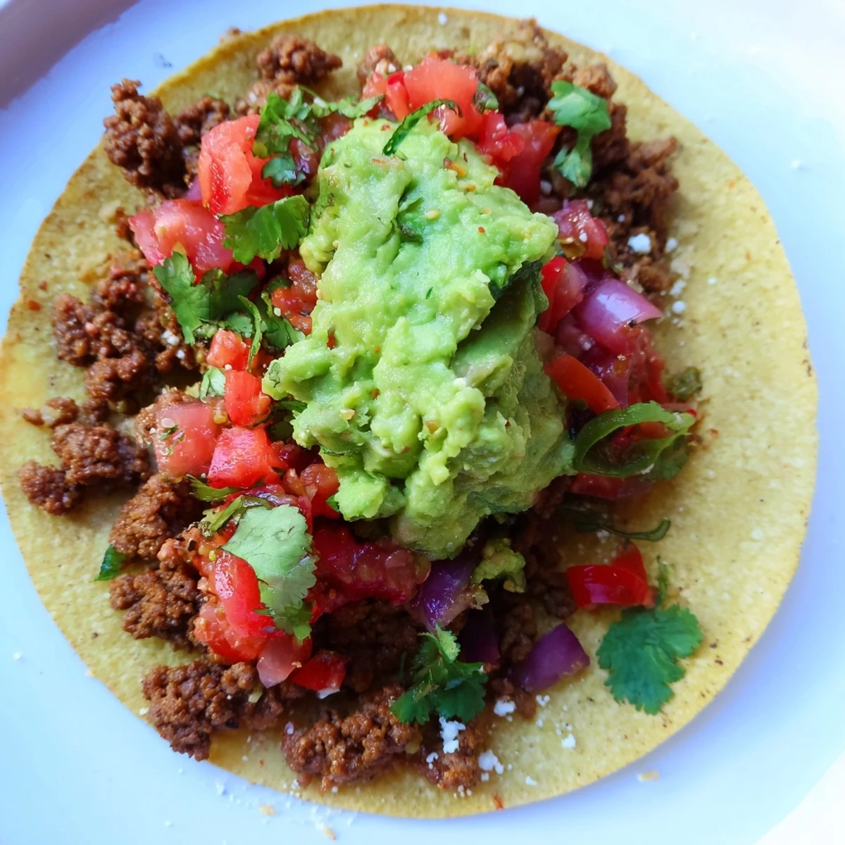 These Mini Tacos with Salsa and Guacamole feature juicy seasoned meat, vibrant salsa, and smooth guacamole on corn tortillas.