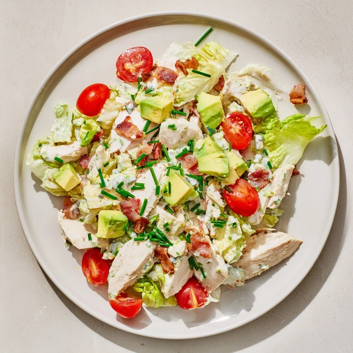 Crispy bacon and juicy chicken slices on romaine lettuce with cherry tomatoes in this BLT Chicken Salad.