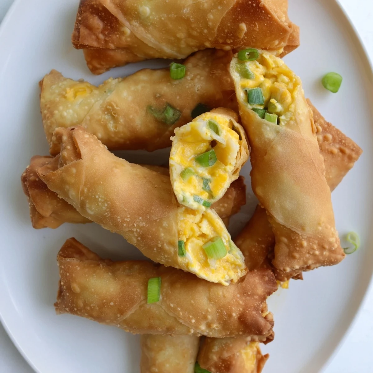 Close-up view of Mini Jalapeño Popper Egg Rolls showing crispy, crunchy wrappers with creamy cheese and jalapeño filling.