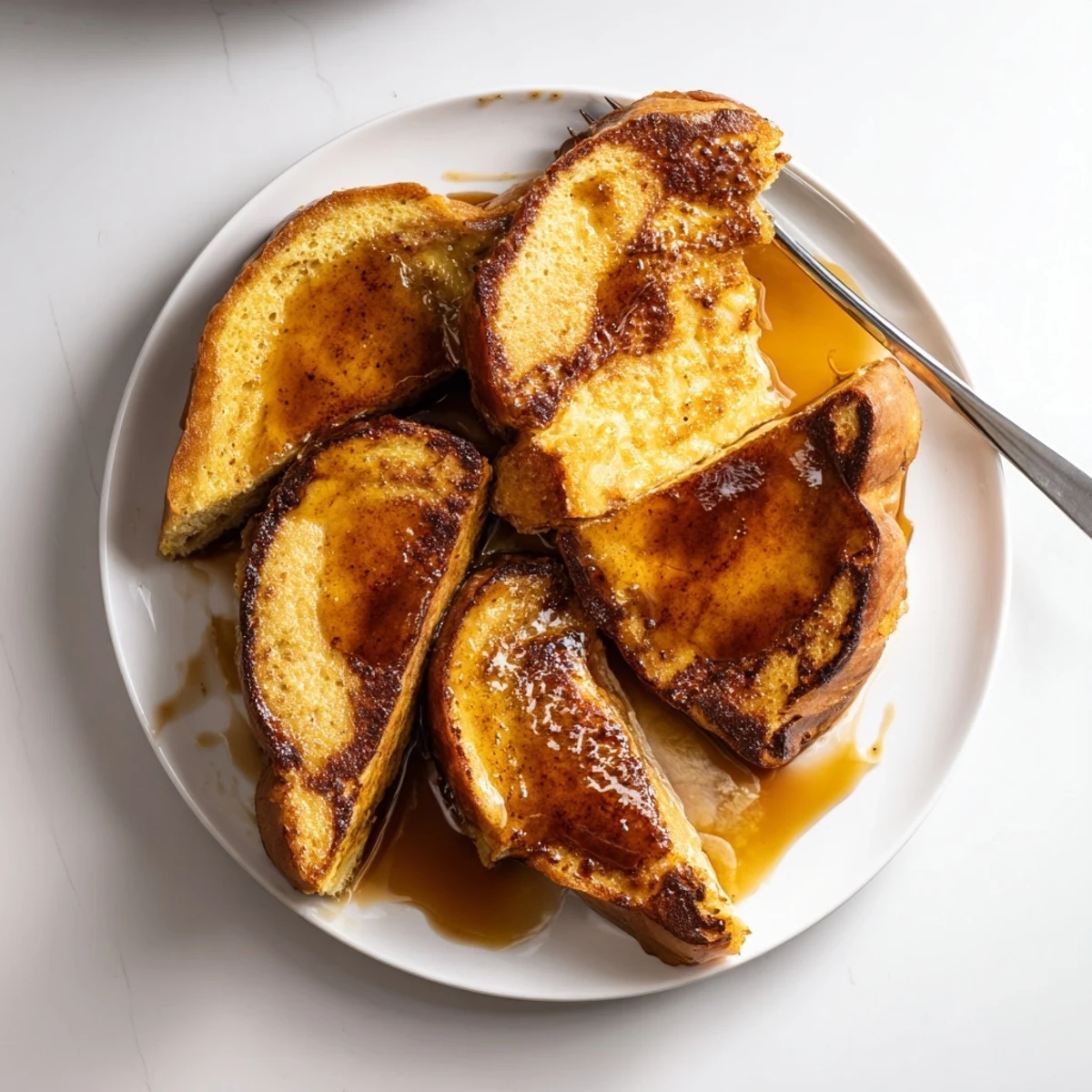 Golden Crème Brûlée French Toast brioche custard soaked and baked, topped with a crackly sugar crust.