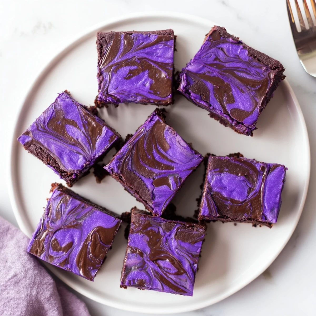 Fudgy ube brownies with marbled chocolate swirl on a white serving plate