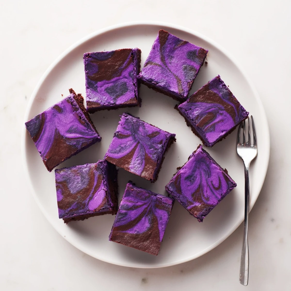 Rich Filipino purple yam brownies topped with melted chocolate drizzle and garnish