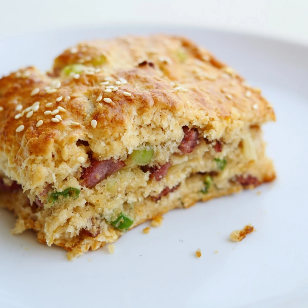 Stack of freshly baked homemade Chinese sausage biscuits showing golden layers and savory diced sausage throughout