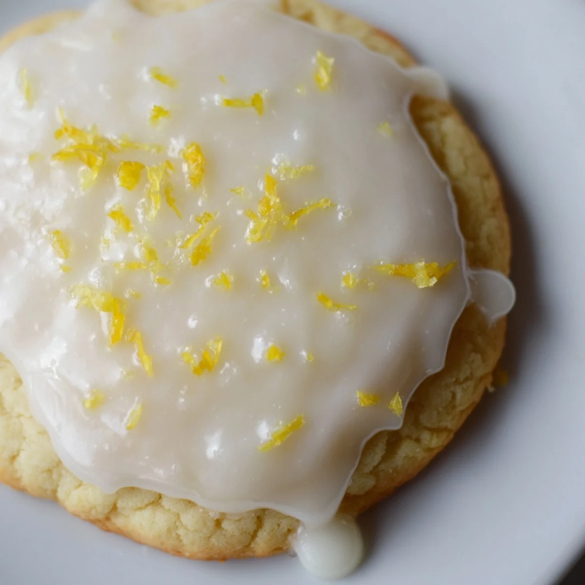 Golden lemon glazed cookies drizzled with sweet frosting and fresh lemon zest