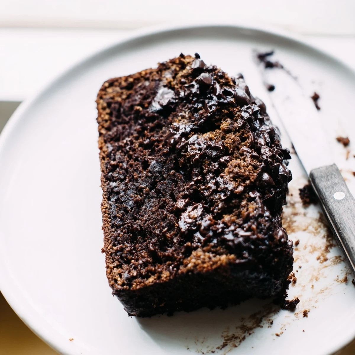 Moist chocolate espresso banana bread loaf studded with melted chocolate chips and sliced thick