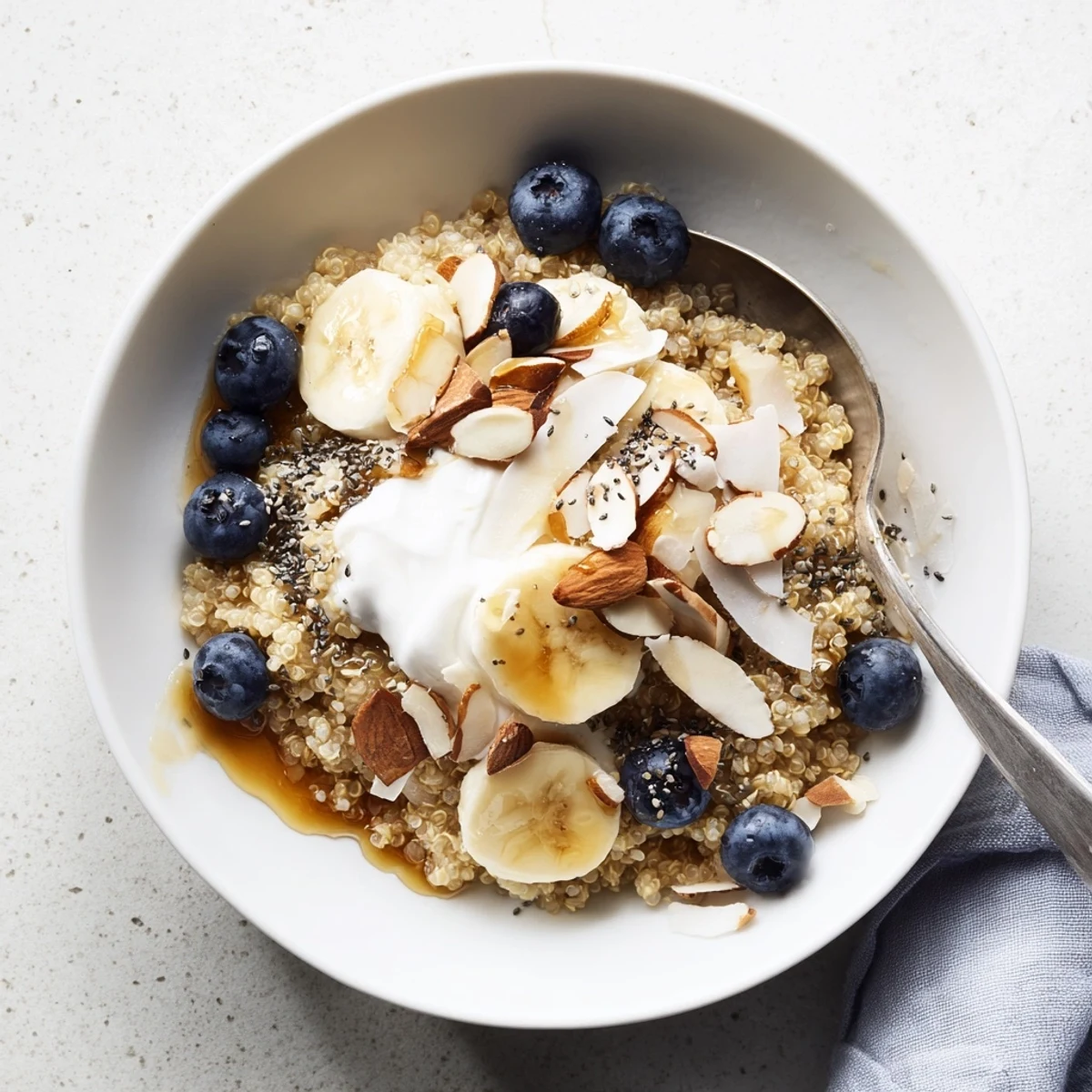 Vibrant blueberry quinoa breakfast bowl featuring plump berries, sliced banana, and nutty toppings for a nutritious morning meal
