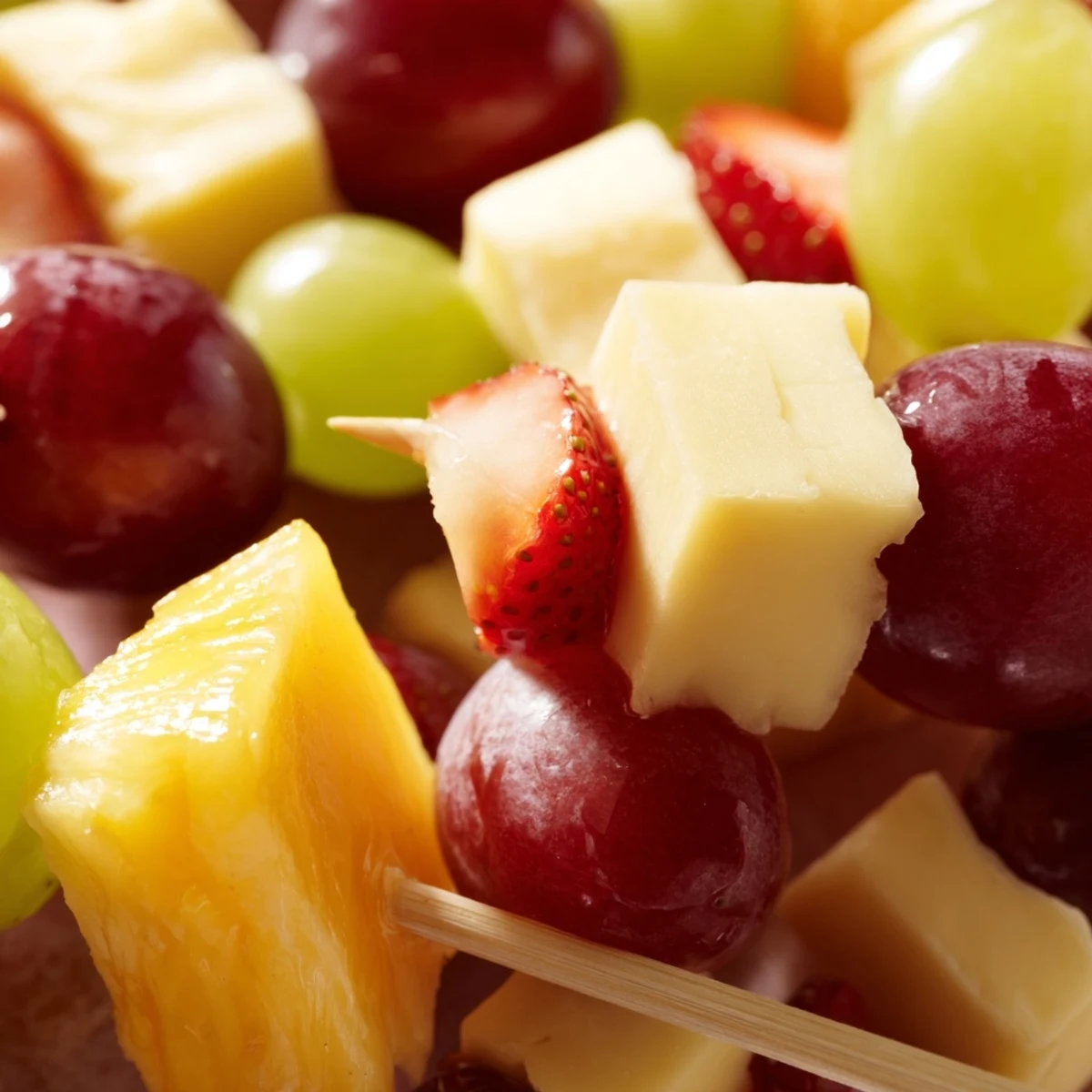 Fresh fruit and cheese kabobs featuring alternating red grapes pineapple chunks and creamy Monterey Jack squares