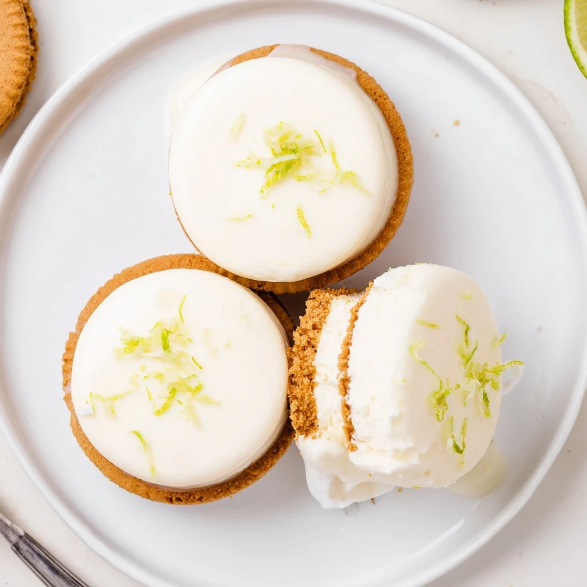 Key Lime Pie Ice Cream Sandwiches stacked, zesty lime filling and graham crumbs