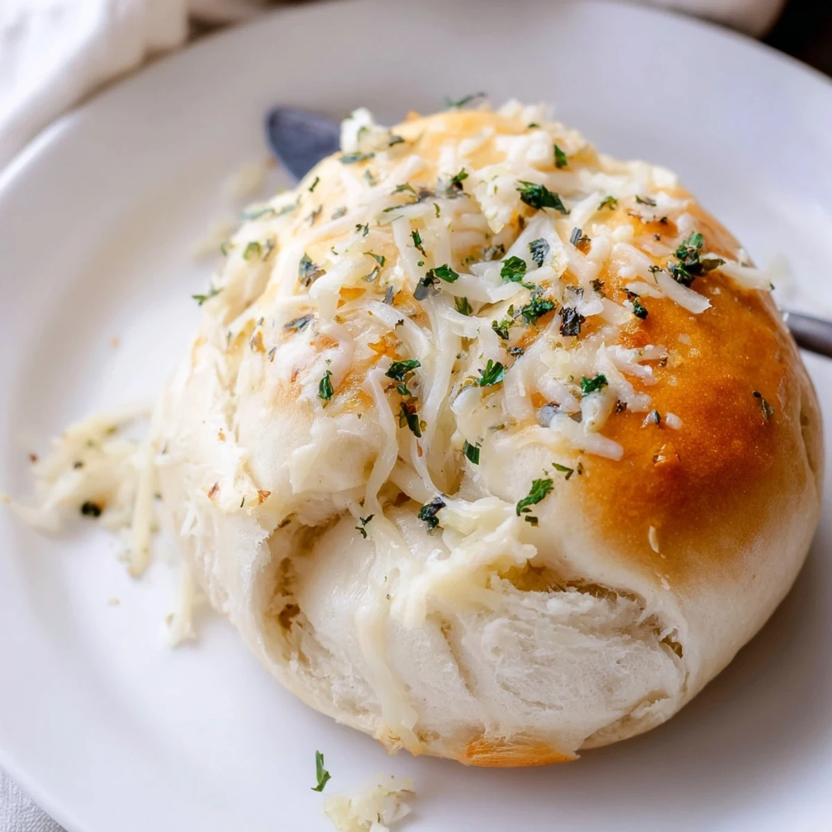 Freshly baked Buttery Cheese Garlic Rolls steaming, torn open to reveal gooey filling