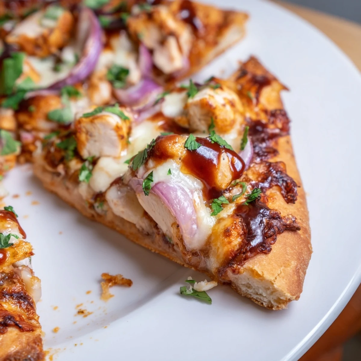 Golden grilled BBQ chicken pizza topped with melted cheese and red onion slices