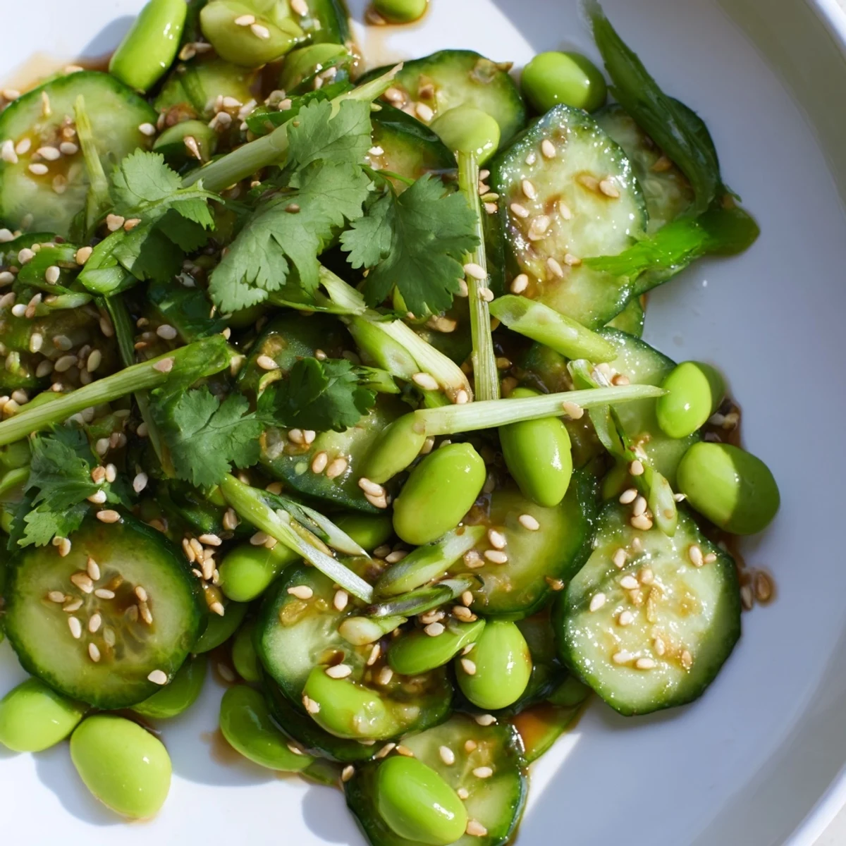 Crisp cucumber slices with tender edamame beans drizzled with savory sesame dressing