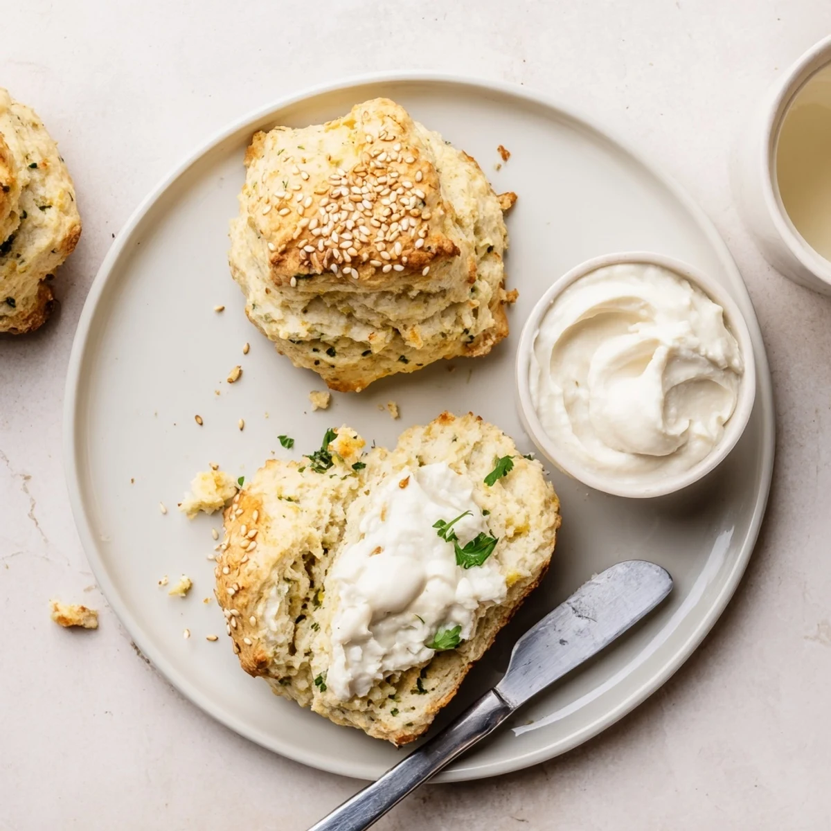 Buttery Humous Scones split open, tangy yogurt dip alongside for brunch.