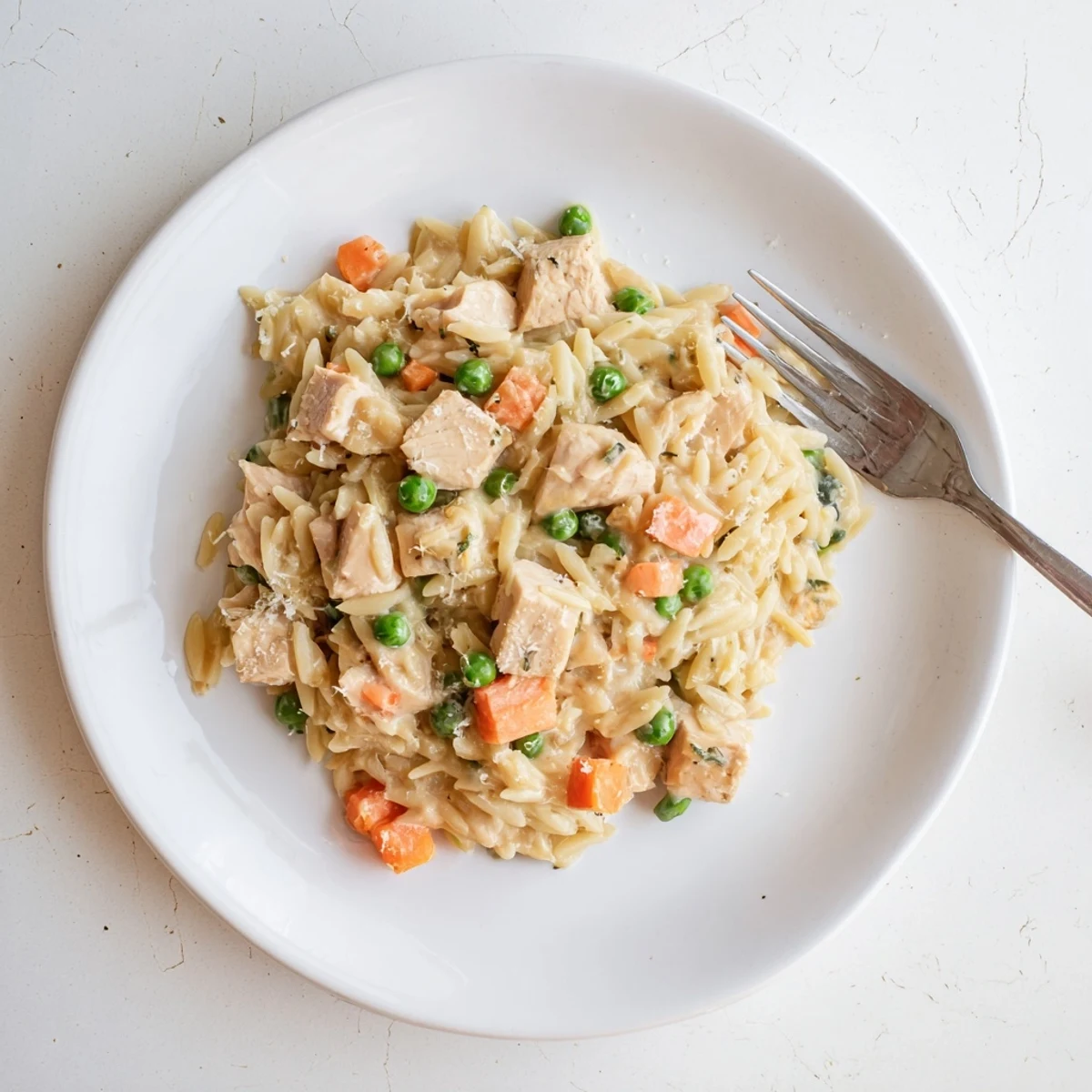 Creamy Chicken Pot Pie Orzo featuring tender chicken and colorful veggies in a rich sauce.