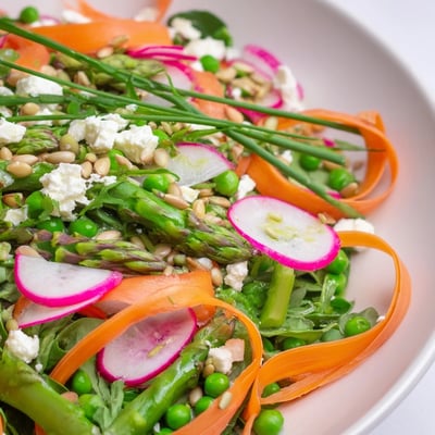 Vibrant Bright Spring Salad topped with crumbled feta and toasted sunflower seeds