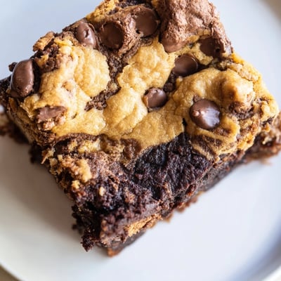 Decadent fudgy chewy brookies fresh from the oven showing golden brownie and chocolate chip cookie marbled texture