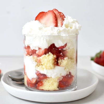 Individual Strawberry Shortcake Trifles in jars, golden shortcake pieces and syrupy strawberries